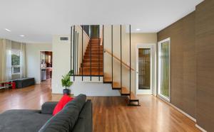 a living room with a couch and a staircase at Beach Villa * Hot Tub * Steps to Beach in Long Beach +50 photos