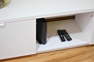 two remote controls are sitting in a drawer at Casa do Chafariz Velho in Angra do Heroísmo