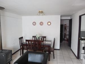a dining room with a table and chairs at Casa Centrica Pucón in Pucón