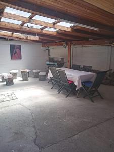a table and chairs in a garage with a table and a grill at Casa Centrica Pucón in Pucón +3 photos