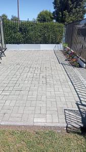 a brick patio with a fence and a bench at Casa Centrica Pucón in Pucón