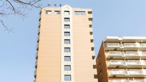a tall building with two birds on the top of it at Toyoko Inn Hokkaido Sapporo-eki Nishi-guchi Hokudai Mae in Sapporo