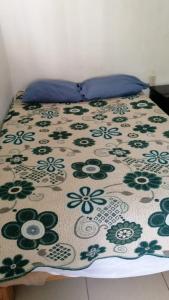 a bed with a flowered blanket on top of it at Pomarrosa in Puerto Vallarta