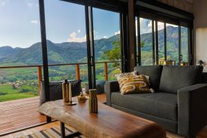 a living room with a couch and a table at Chalé - Vila Bertina in Gonçalves