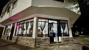 a building with a window with curtains in it at Hotel Zenit in Mar de Ajó