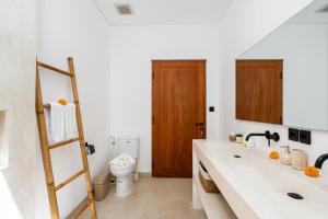 a bathroom with a sink and a toilet at Villa Casamo in Bali in Badung