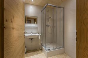 a bathroom with a shower and a sink at Appartements Lilly Rose in Zell am Ziller