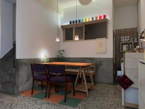 a small kitchen with a wooden table and chairs at 可以住Canlive中西區海安路包棟民宿-一日只接待一組 in Tainan