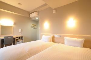 Postelja oz. postelje v sobi nastanitve AB Hotel Tahara