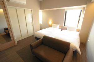 Postelja oz. postelje v sobi nastanitve AB Hotel Tahara