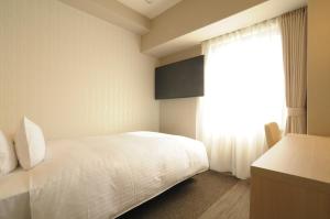 Postelja oz. postelje v sobi nastanitve AB Hotel Tahara