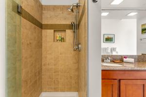 a bathroom with a shower and a sink at Poipu Sands 437: 2BR Ocean View Condo w/ A/C, pool in Koloa +25 photos