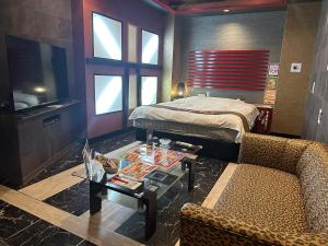 Postel nebo postele na pokoji v ubytování ホテルロサージュ