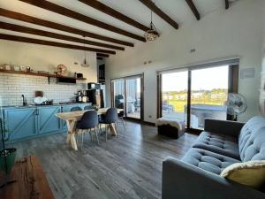 a living room with a couch and a table at Cabañas Lawal Puerto Varas 2 in Puerto Varas