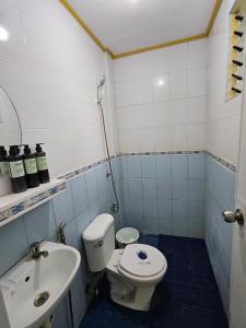 a bathroom with a toilet and a sink at Mel's Place Batangas Unit 4 Vista De Oro 2 Bedroom House w Free Parking, Google TV WIFI Netflix 4 Guests in Batangas City +12 photos