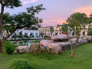 a view of a building with a garden and rocks at DAD Resort Phú Quốc in Phú Quốc