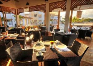 een restaurant met tafels en stoelen in een kamer bij 2BR 2BA Beachfront Cadaques Caribe in Bayahibe