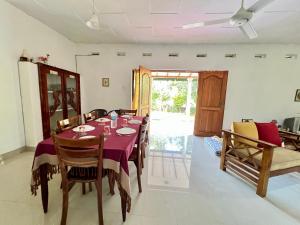 a dining room with a table with a purple table cloth at Sepalika Homestay in Kandy