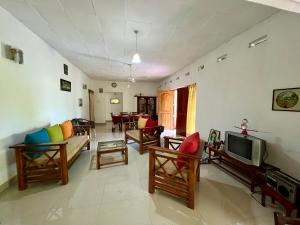a living room filled with furniture and a tv at Sepalika Homestay in Kandy