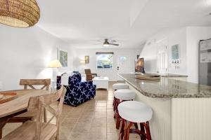 a kitchen and living room with a table and chairs at Sandcastles and Sunshine - Gulf Highlands Beach Resort in Panama City Beach