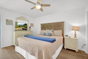 a bedroom with a bed and a ceiling fan at Sandcastles and Sunshine - Gulf Highlands Beach Resort in Panama City Beach +28 photos
