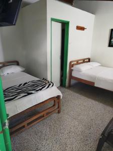 Letto o letti in una camera di Hotel Casa Verde Guatapé
