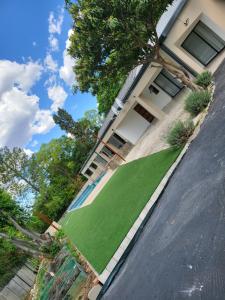 a yard of green grass in front of a house at Limewood 2 in Sandton