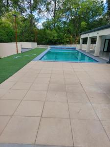 a swimming pool in a yard with a tile floor at Limewood 2 in Sandton