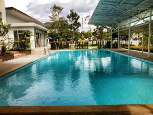 a large blue swimming pool in a building at Ingfah Mountainview in Hat Yai