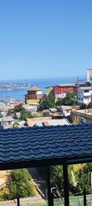a view of a city with a blue roof at Ocean View & Pool Family Apartment 4P in Valparaíso