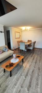 a living room with a couch and a table at Ocean View & Pool Family Apartment 4P in Valparaíso