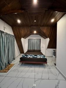 a bedroom with a bed in the middle of a room at Verdant peaks Homestay in Vagamon +10 photos