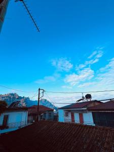 a cow sitting on the roof of a house at Alfeios cozy stays - Attic in Pyrgos +6 photos