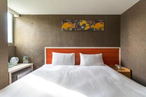 Postel nebo postele na pokoji v ubytování E Lim Hotel