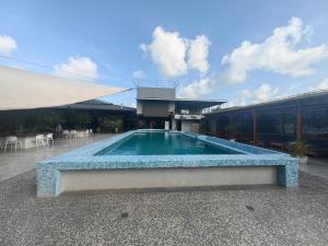 a swimming pool in front of a building at Royal International Hotel & Mall in Georgetown