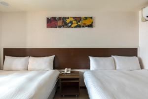 Postel nebo postele na pokoji v ubytování E Lim Hotel