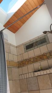 a bathroom with a tiled wall and a ceiling at Amazing Getaway Oceanview with treehouse feel in Manchester +24 photos
