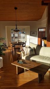 a living room with a couch and a table at Amazing Getaway Oceanview with treehouse feel in Manchester