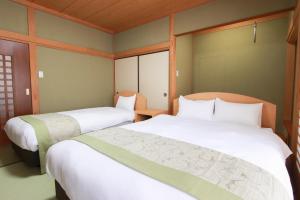 Postel nebo postele na pokoji v ubytování HOTEL DO-YA BEPPU Bekkan + 19 fotografií