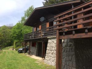 a stone house with a car parked next to it at Chalet Braunkopf ALSACE in Muhlbach-sur-Munster