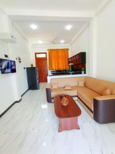 a living room with a couch and a table at Luxury Peak Villa in Mirissa