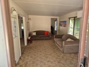 a living room with two couches and a couch at Gunyah Valley Retreat in Goornong