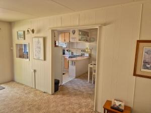 a room with a kitchen and a room with a hallway at Gunyah Valley Retreat in Goornong