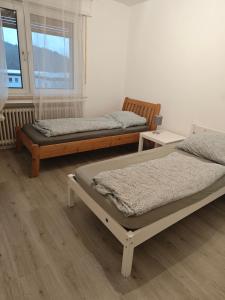 a room with two beds and a window at Work and Stay Plettenberg 90 Qm 7 Betten 3 Schlafzimmer mit Balkon und Kraftraum 44 oben in Plettenberg +56 photos