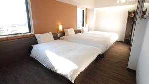 A bed or beds in a room at AB Hotel Kakamigahara