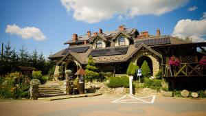 a large house with a lot of solar panels on it at Hotel Restauracja Jaś Wędrowniczek in Rymanów