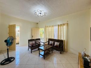 a living room with two chairs and a table at AisG Homestay Tres -Fully Furnished Shared Homestay FREE NETFLIX-3mins to Airport in Puerto Princesa City