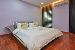 a bedroom with a large bed with white sheets and pillows at Spacious 12 pax Landed Homestay By NexxField in Ampang