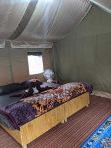 a bedroom with a bed in a tent at Soma Caves Tents in Jagatsukh