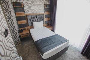 A bed or beds in a room at Prusias Otel